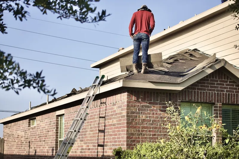 Professional roofer working on a residential roof in Lincoln Knolls
